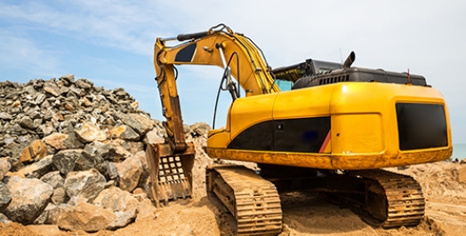 Excavation mashine works in a quarry. Yellow earth mover digging sand